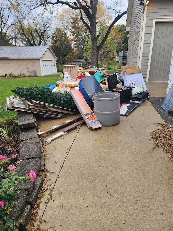 Dumpster being loaded with debris for Estate Cleanout Dumpster Rental in Walnut Park